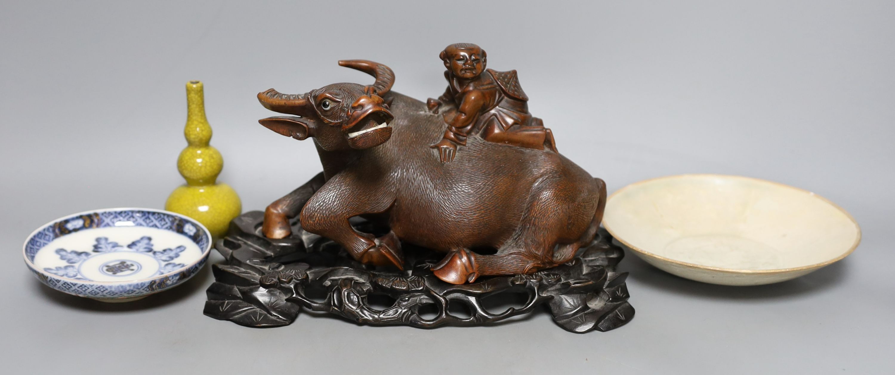 A Chinese studio pottery dish together with another two Chinese ceramics and a wood ox group, 26cm long, (4)